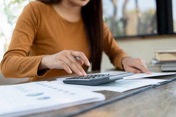 Young woman engages in note-taking at workspace.