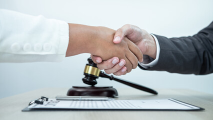Male lawyer shaking hands with client after good deal negotiation cooperation meeting in courtroom