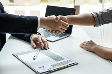 Good deal of interview, Business people and recruiter shaking hands greeting or get acquainted of conducting a job interview while sitting at the working meeting in office