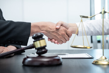 Male lawyer shaking hands with client after good deal negotiation cooperation meeting in courtroom