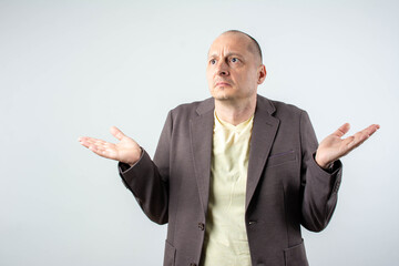 Confused businessman standing on isolated background with blank copy space