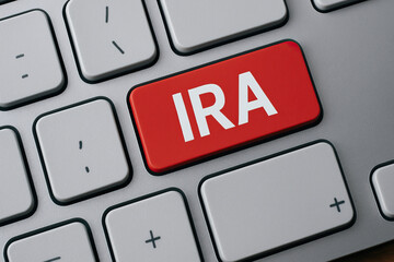 Individual retirement account concept with red key on computer keyboard, financial planning and investment idea for future savings