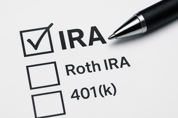 Individual retirement account option with checkmark on IRA choice, pen on white paper, financial planning concept for savings and investment decisions