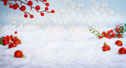 Obraz na płótnie Canvas Christmas Holiday background with snow, fir tree and decorations with christmas light behind. Christmas red balls on a winter festive background.