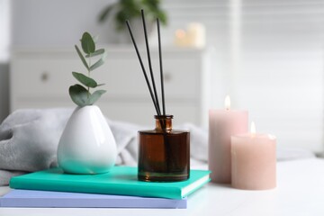 Spa composition with reed air freshener on white table indoors, closeup