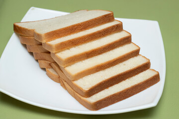 Freshly baked white milk bread on a white plate side view of Bangladeshi food