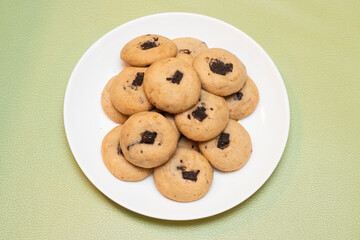 Freshly baked chocolate chip cookies on a plate side view of Bangladeshi food