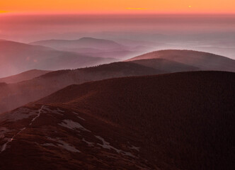 Stunning mountain range at sunset with pink skies for adventure travel and outdoor lifestyle brands