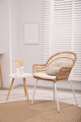 Comfortable armchair and side table in living room. Interior design