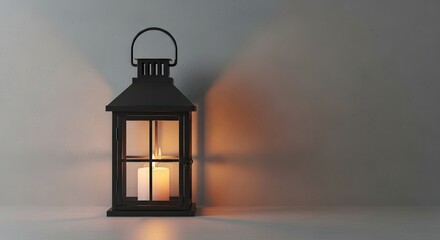 A black lantern with a lit candle casting shadows on a neutral-toned wall.