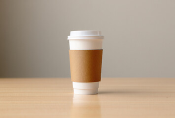 Single disposable coffee cup with brown sleeve on wooden table