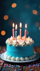 Blue birthday cake, candles lit, festive writing, frosting, candlelight