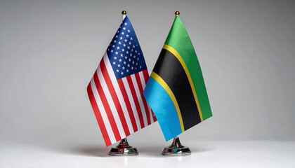 Side-by-side display of the United States and Tanzania flags on flagpoles, representing diplomatic ties and international cooperation.