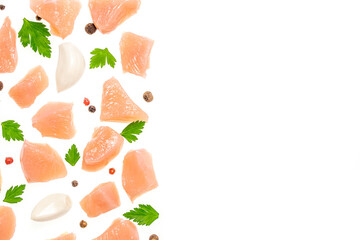 Raw chicken breast cubes with garlic parsley and pepper on white background. top view. copy space