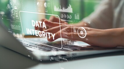 Focused Hands Typing on Laptop with Overlay of Data Integrity Concept and Digital Analytics Elements. Asymptotic smart data analytic.