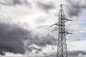 High voltage electricity pylon with dramatic sky in Zaragoza, Spain, representing connection between renewable energy sources and modern power distribution in European infrastructure