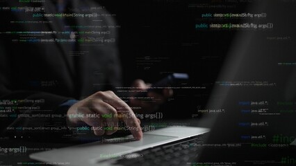 A focused programmer operates a laptop while using a smartphone in a dark setting. Floating code and binary elements create a high-tech atmosphere, ideal for tech-related projects. Xenic