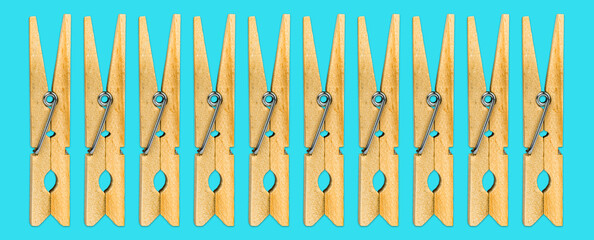 Minimalistic Wooden Clothespins on Cyan Background