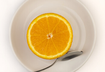 Half Orange Slice on White Plate with Spoon – Healthy Food Concept