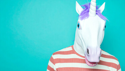 Unicorn mask person in striped shirt against teal background