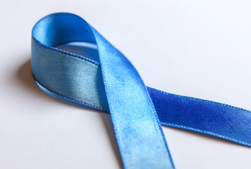 Blue ribbon on a white background is a symbol of theproblem of Stevens-Jones sndrome, colon cancer, probem of hydranencephaly, chrnic fatigue syndrome, myalic encephalomyelitis. Weekno smoking