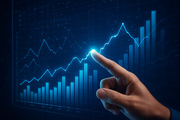 Close-up of hand pointing at glowing financial growth chart with rising bar and line graphs on digital screen