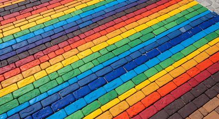 Colorful brick pavement showing a rainbow pattern in diagonal lines