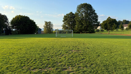 Football goal on green grass field, outdoor sports training equipment, soccer net closeup, empty playground background, recreational activity area, professional match preparation, athletics concept, c