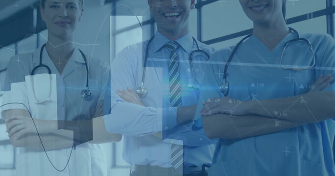 Standing three medical professionals in lab coats, scrubs and ties in clinic, viewing digital data
