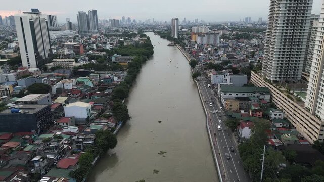 Drone video showcase an aerial view of Pasig river running through the city of Manila, the capital and the most populous city in Philippines