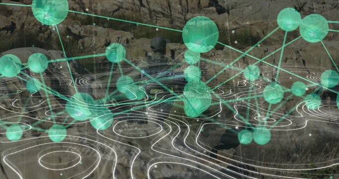 Exploring lone man navigating rocky canyon by water, glowing green data nodes with contour lines