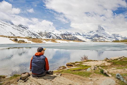 Man Relaxing by Mountain Lake