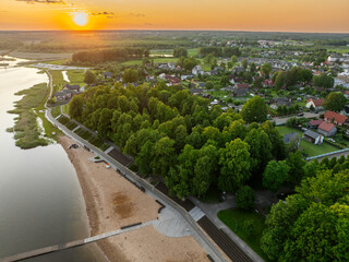 Aerial view of Võru, Estonia at sunset, featuring the serene Tamula Lake and surrounding...