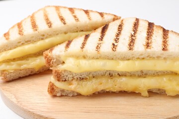 Tasty sandwiches with melted cheese on table, closeup