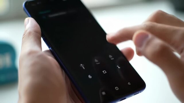 Fingers navigating a smartphone display with readable text