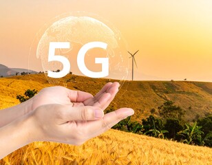 5G Technology Symbol Held in Hand Over Wheat Field with Wind Turbines at Sunset.
