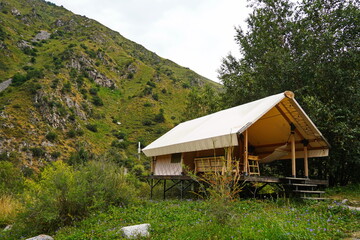 Glamping. Gazebo with hammock in a mountainous area.
