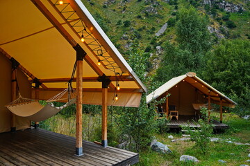 Glamping. Gazebo with hammock in a mountainous area.