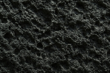 Close up textured abstract background of dark rough organic material
