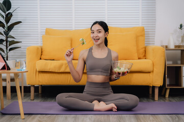 Obraz premium Woman Eating Salad After Workout at Home