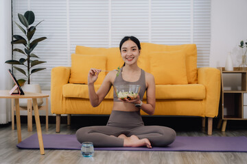 Fototapeta premium Healthy Woman Eating Salad at Home