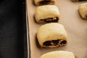 Raw poppy seed buns raw pastry dough baking sweet dessert tasty snack fresh delicious gourmet food background on the table rustic top view copy space
