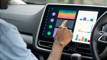 Obraz premium personalized ai solutions A person interacting with a modern car touchscreen displaying various data and graphics.