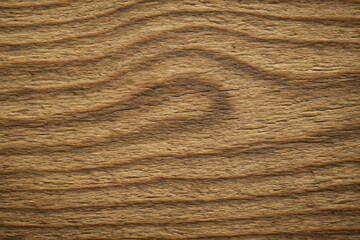 Close up of natural brown wood grain texture with wavy patterns