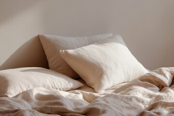 Minimalist bedroom scene with neutral linen bedding and soft pillows, bathed in warm natural light for a tranquil and cozy atmosphere