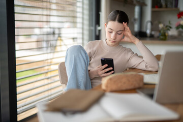 Stressed teenager checking her phone