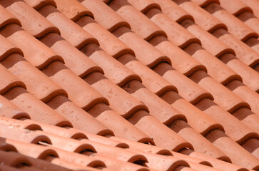 Close-up of terracotta roof tiles with wave patterns and textures