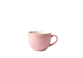 Obraz premium A light pink teacup, filled with a brew, sits against a black backdrop, showcasing the delicate details of the porcelain.