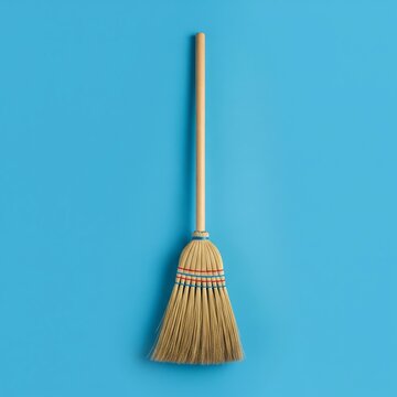broom isolated on blue background 