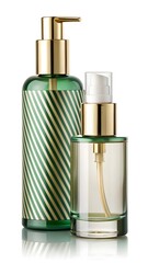 Naklejka premium Elegant green and clear glass bottles with gold pumps
